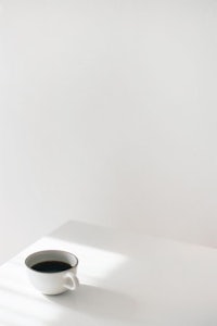 a cup of coffee on a white table