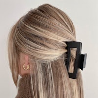 the back of a woman's hair with a black hair clip